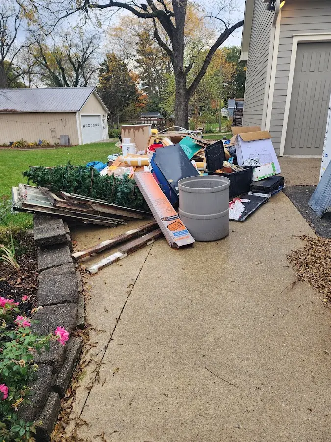 Dumpster being loaded with debris for 10 Yard Dumpster Rental in Lake St. Louis
